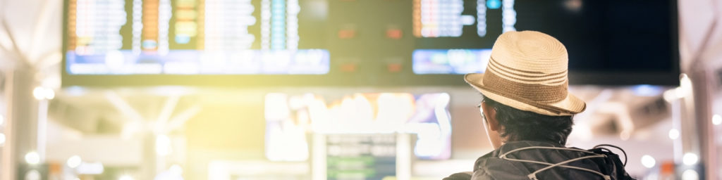 customer looking at flight information screens